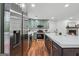 Kitchen boasts a modern island with seating, stainless steel appliances, and a fireplace nearby at 4327 Welligton Hill Ln, Snellville, GA 30039