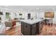 Open concept kitchen flows into the living area; island has a wine fridge at 4327 Welligton Hill Ln, Snellville, GA 30039