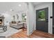 Bright living room with fireplace, hardwood floors, neutral decor, and a doorway with a view to the outdoors at 4327 Welligton Hill Ln, Snellville, GA 30039