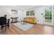 Bright living room featuring yellow sofa, modern decor, and hardwood floors throughout at 4327 Welligton Hill Ln, Snellville, GA 30039