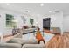 Spacious and bright living room with hardwood floors, fireplace, and comfortable seating for gatherings at 4327 Welligton Hill Ln, Snellville, GA 30039
