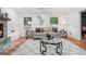 Cozy living room featuring stylish furnishings, neutral color palette, fireplace, and hardwood floors at 4327 Welligton Hill Ln, Snellville, GA 30039