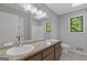 Bathroom showcasing a double vanity with granite countertops, ample lighting, and modern fixtures at 4811 Nevilly Way, Marietta, GA 30066