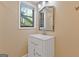 Bathroom featuring a vanity, a framed mirror, and a view through the window at 4811 Nevilly Way, Marietta, GA 30066