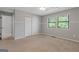 A cozy bedroom featuring neutral paint, carpet flooring, and a bright window view at 4811 Nevilly Way, Marietta, GA 30066