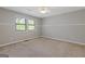 Neutral bedroom featuring carpeted floors and two windows at 4811 Nevilly Way, Marietta, GA 30066