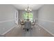 Formal dining room with stylish chandelier and seating for six at 4811 Nevilly Way, Marietta, GA 30066