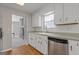 Kitchen features stainless steel appliances, white cabinets, and a view to the living room at 4811 Nevilly Way, Marietta, GA 30066