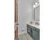 Well-lit bathroom with shiplap accent walls and a blue vanity at 120 Hermitage Pl, Peachtree City, GA 30269
