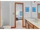 Bathroom featuring a wooden vanity with view into an adjacent bedroom at 120 Hermitage Pl, Peachtree City, GA 30269