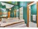 A bathtub inside of a bathroom with a shower and green walls at 120 Hermitage Pl, Peachtree City, GA 30269