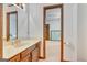 Bathroom vanity featuring a golden faucet, wooden cabinets, and a view into another room at 120 Hermitage Pl, Peachtree City, GA 30269