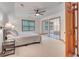 Bright bedroom features neutral decor, tray ceiling, ceiling fan, and mirrored closet doors at 120 Hermitage Pl, Peachtree City, GA 30269