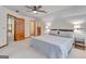 Spacious bedroom with a ceiling fan, plush carpet, and a comfortable king-size bed at 120 Hermitage Pl, Peachtree City, GA 30269