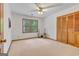 Bedroom featuring hardwood floors, guitars, a large window, and a closet at 120 Hermitage Pl, Peachtree City, GA 30269