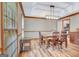 Cozy dining room with wood floors, modern light fixture, and natural light at 120 Hermitage Pl, Peachtree City, GA 30269