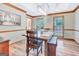 Bright dining room featuring natural light, a wooden table, and comfortable seating at 120 Hermitage Pl, Peachtree City, GA 30269