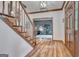 Warm and welcoming home foyer with hardwood floors, decorative trim, and a view of the study at 120 Hermitage Pl, Peachtree City, GA 30269