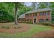 Beautiful two-story brick house with traditional black shutters and a meticulously manicured front lawn at 120 Hermitage Pl, Peachtree City, GA 30269