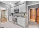 Kitchen with stainless steel stove and microwave with easy access to other rooms in the house at 120 Hermitage Pl, Peachtree City, GA 30269