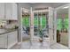 Kitchen with double doors leading to a screened-in patio with furniture at 120 Hermitage Pl, Peachtree City, GA 30269
