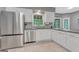 Well-lit kitchen featuring stainless steel appliances, a window, and gray countertops at 120 Hermitage Pl, Peachtree City, GA 30269