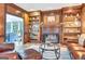 Inviting living room with a brick fireplace and classic built-in shelving at 120 Hermitage Pl, Peachtree City, GA 30269