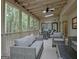 Screened patio with outdoor furniture, ceiling fan, and a view of the woods at 120 Hermitage Pl, Peachtree City, GA 30269