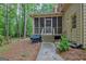 View of a cozy screened-in porch featuring wooden railings and a door leading to a lush backyard at 120 Hermitage Pl, Peachtree City, GA 30269