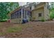 Side view of the screened porch with view of backyard and mature trees at 120 Hermitage Pl, Peachtree City, GA 30269