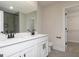 Double vanity bathroom featuring black fixtures and a mirror reflecting the walk-in closet and tiled shower at 432 Cantrell Drive, Dallas, GA 30157