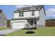 Well-maintained two-story home with a two-car garage, complemented by a green lawn and tasteful landscaping at 432 Cantrell Drive, Dallas, GA 30157