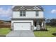 Charming two-story home featuring a white exterior, a two-car garage, and a well-manicured lawn at 432 Cantrell Drive, Dallas, GA 30157