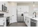 Clean, bright kitchen featuring stainless steel appliances, white cabinets, and modern fixtures at 432 Cantrell Drive, Dallas, GA 30157