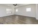 Spacious living room with hardwood floors, bright windows, and a ceiling fan for added comfort at 432 Cantrell Drive, Dallas, GA 30157