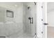 Tiled shower with glass door and matte black fixtures in updated bathroom at 432 Cantrell Drive, Dallas, GA 30157