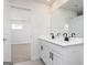 Bathroom vanity featuring double sinks, sleek black faucets, and a large mirror with walk in closet view at 488 Cantrell Drive, Dallas, GA 30157