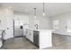 Bright kitchen boasts a large island with a stainless steel dishwasher, black faucet, and pendant lighting at 488 Cantrell Drive, Dallas, GA 30157