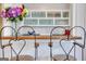 Cute bar area with wooden counter, bar stools, overhead cabinets, and glassware display at 300 Peachtree Ne Ave # 22N, Atlanta, GA 30305