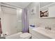 Clean bathroom featuring a shower-tub combo, white tile, and modern fixtures at 300 Peachtree Ne Ave # 22N, Atlanta, GA 30305