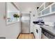 Efficient kitchen featuring white cabinets and stainless steel appliances, view to living area at 300 Peachtree Ne Ave # 22N, Atlanta, GA 30305