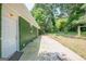 View of the exterior featuring a concrete patio and a spacious yard with mature trees, offering a serene outdoor space at 4806 Rockbridge Rd, Stone Mountain, GA 30083