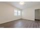 An interior of the bedroom featuring modern hardwood flooring and a window with white trim, creating a bright and inviting space at 4806 Rockbridge Rd, Stone Mountain, GA 30083
