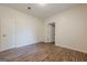 A bedroom with wood-look floors, neutral walls, and white doors at 4806 Rockbridge Rd, Stone Mountain, GA 30083