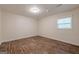 A bedroom featuring wood-look floors, white walls, and a bright window at 4806 Rockbridge Rd, Stone Mountain, GA 30083