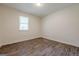 A bedroom with light-filled interior featuring wood-look floors and white trim at 4806 Rockbridge Rd, Stone Mountain, GA 30083