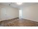 This light-filled bedroom features new wood-look flooring and neutral walls at 4806 Rockbridge Rd, Stone Mountain, GA 30083
