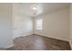 This light-filled bedroom features new wood-look flooring, a window, and a convenient closet at 4806 Rockbridge Rd, Stone Mountain, GA 30083