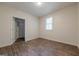 A bedroom showing wood-look floors, neutral walls, and a closet at 4806 Rockbridge Rd, Stone Mountain, GA 30083