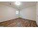 A bedroom showing wood-look floors, white walls, and a bright window at 4806 Rockbridge Rd, Stone Mountain, GA 30083
